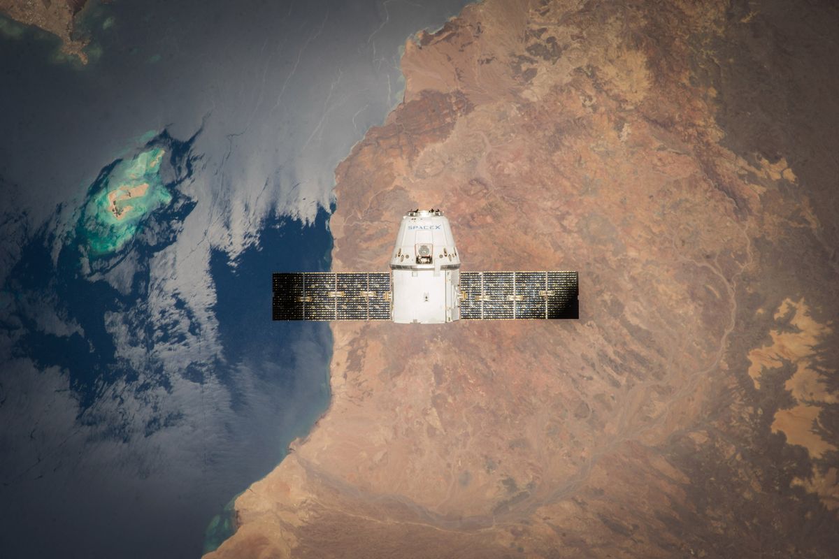 Satellite with solar panels orbiting above the Earth